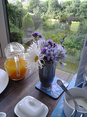 Window dining table with view across garden 